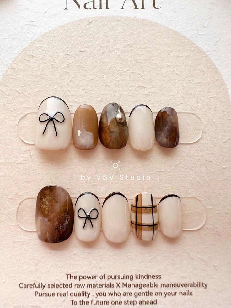 Sophisticated Nail Design Featuring Neutral Tones, Bows, and Glossy Finish