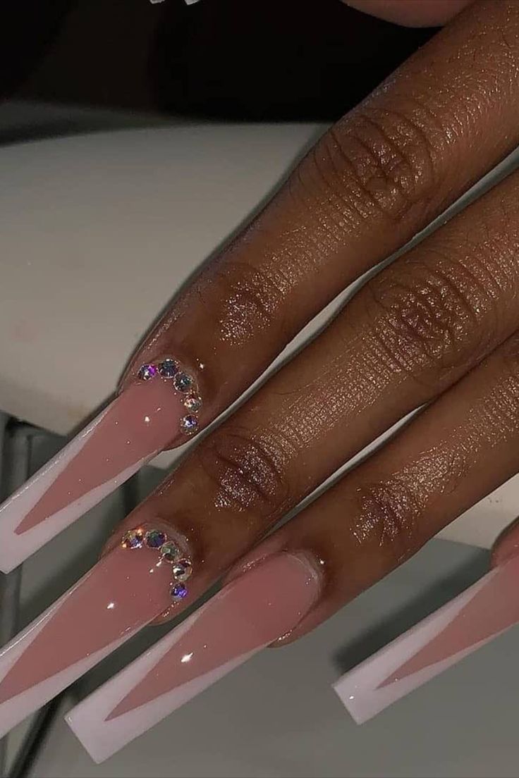 Chic Stiletto Nail Design: Soft Pink and Glossy White with Rhinestone Accents