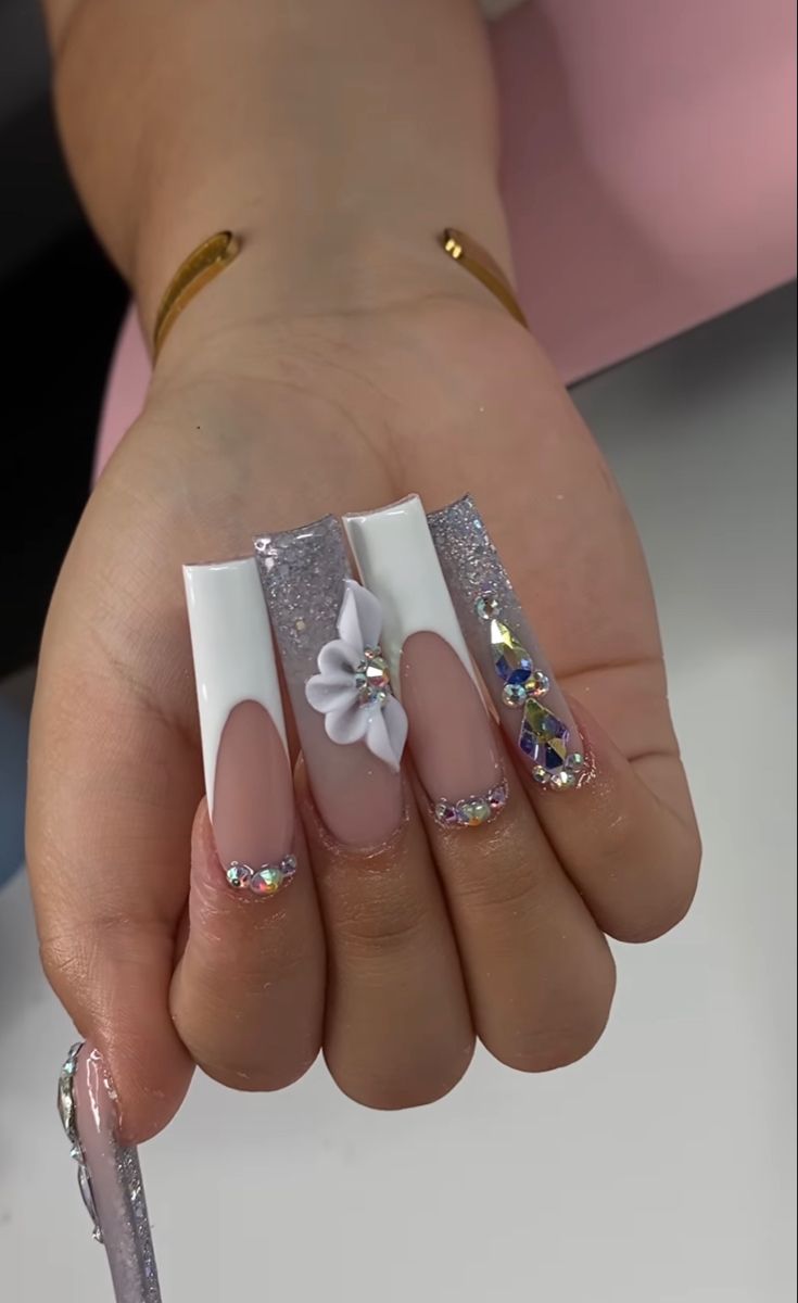 Chic Elegant Nail Design with Square Tips, Floral Accents, and Sparkling Embellishments.