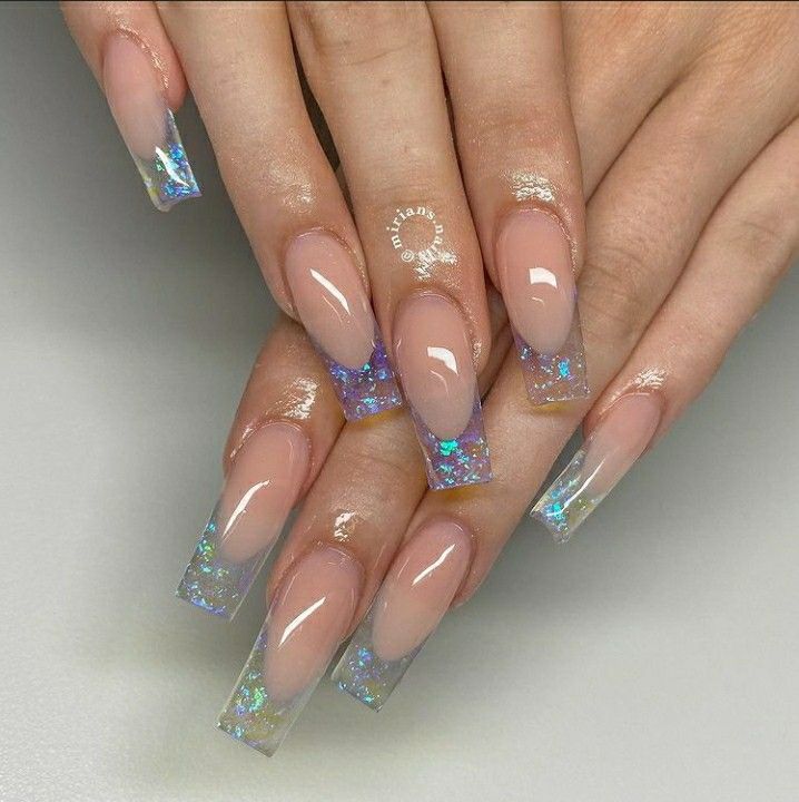 Sophisticated Nail Design: Nude Base with Mesmerizing Holographic Tips and Iridescent Glitter.