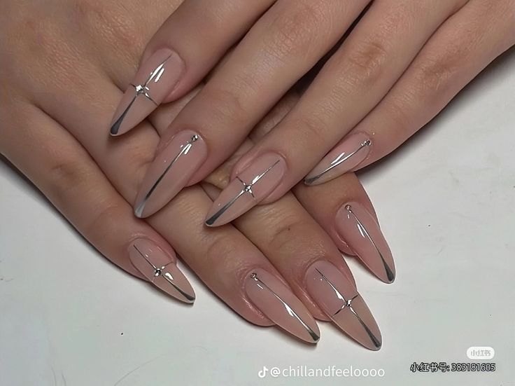 Chic Almond-Shaped Nails with Nude and Metallic Finishes and Glamorous Accents