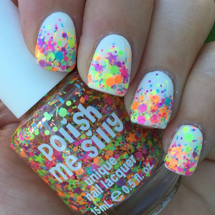 Vibrant Summer Nail Design with Neon Speckles and Gradient Tips.