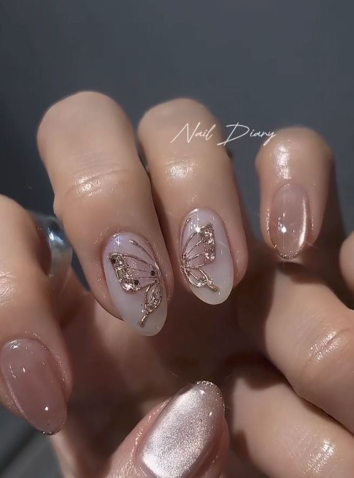 Chic Nail Design with Butterfly Motifs and Gold Accents for a Sophisticated Look.