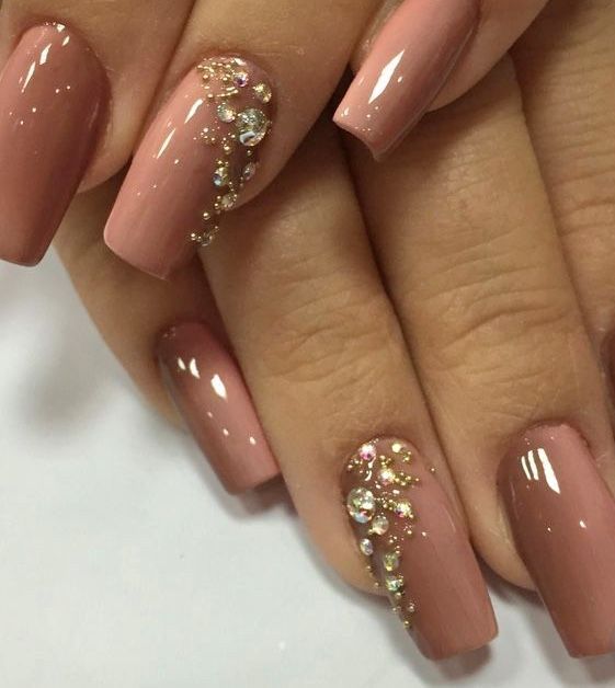 Chic Nude Nail Design with Glossy Finish and Elegant Rhinestone Accents.