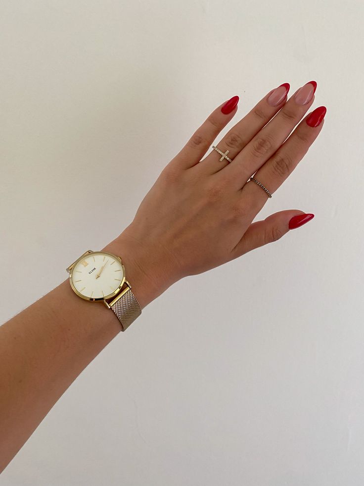 Chic Sophistication: Elegant Red Nail Design Complemented by Gold Accessories.