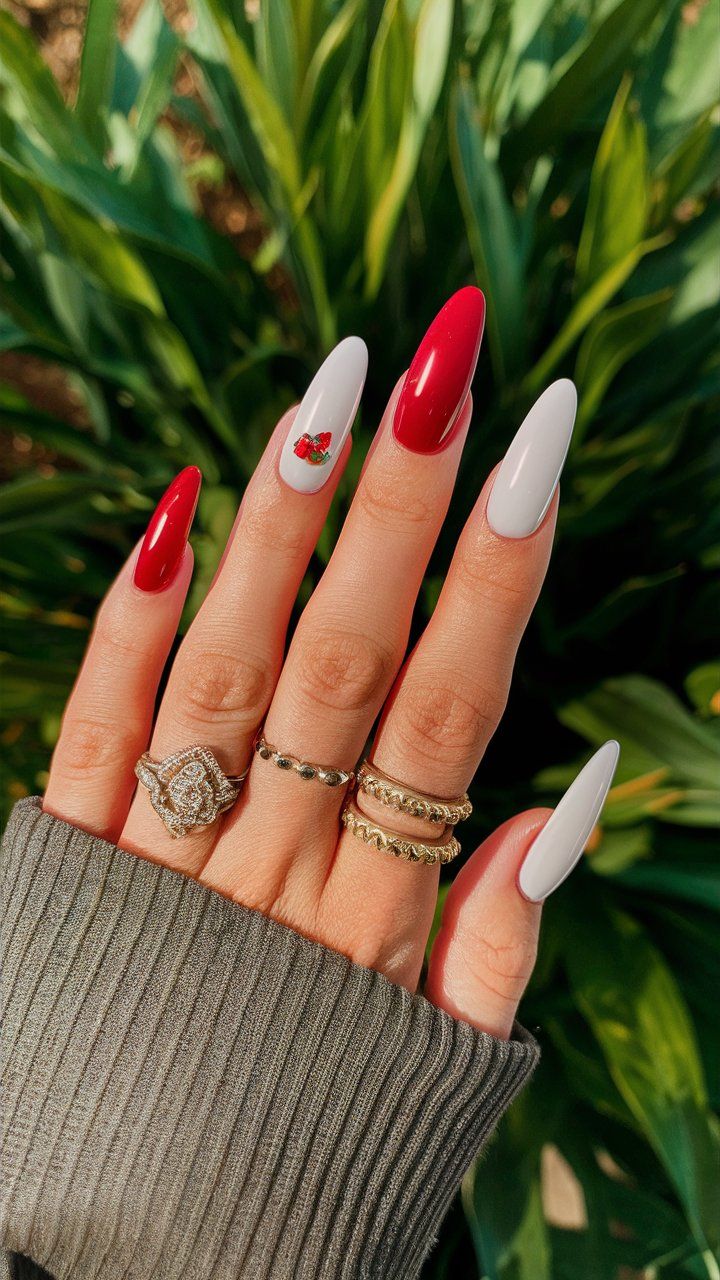 Chic Red and White Nail Design with Playful Cherry Accent.