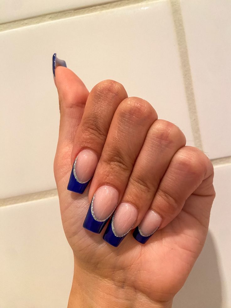 Vibrant Blue Modern French Tip Nails with Elegant Silver Accents.