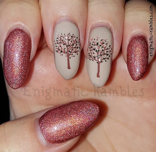 Elegant Nude Nail Design with Delicate Tree Illustrations and Sparkling Deep Rose Gold Accents.