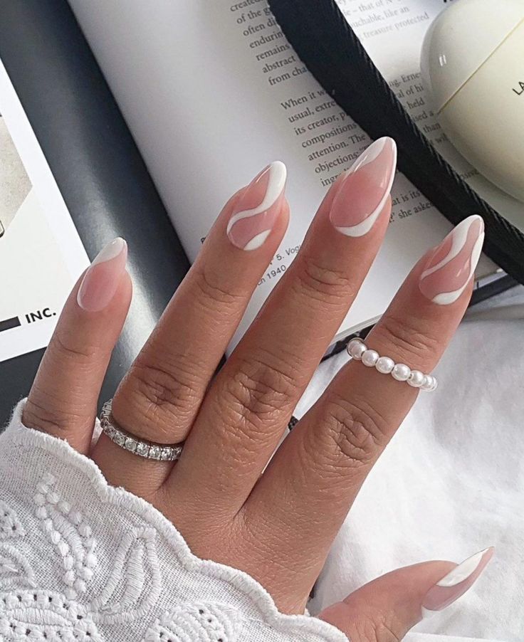 Sophisticated Nude and White Nail Design with Artistic Swirls and Delicate Accents.