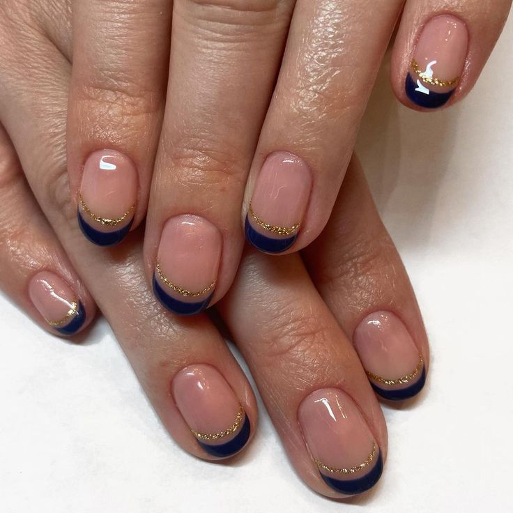 Sophisticated French Tip Manicure with Navy Tips and Gold Accents