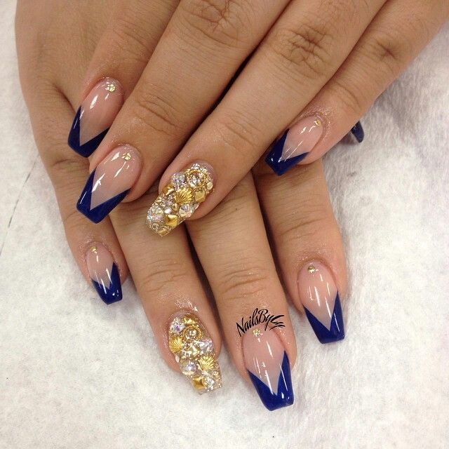 Chic Nude and Deep Navy Nail Design with Glamorous Gold and Gem Accents.