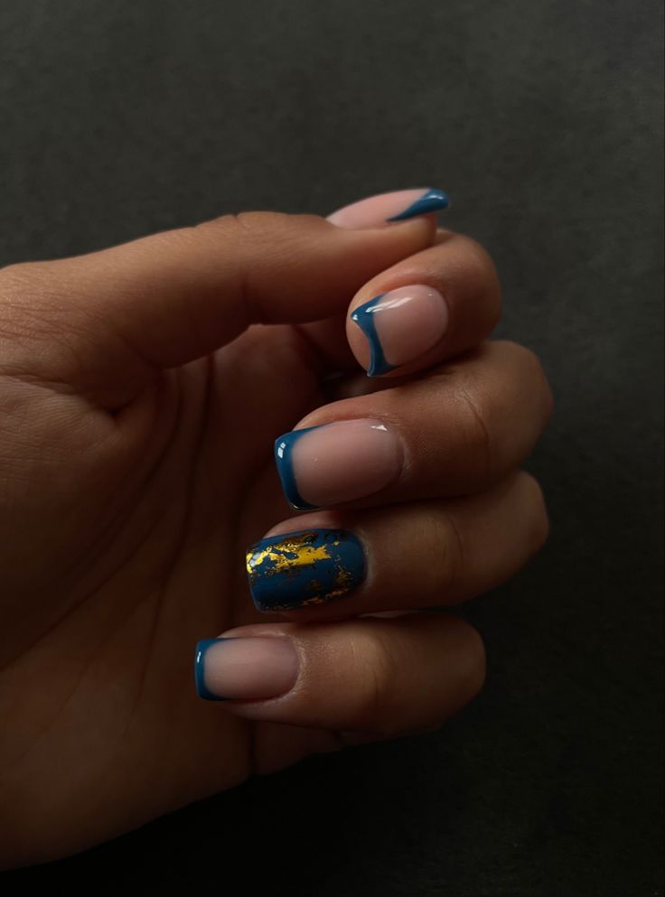 Chic Modern French Manicure with Bold Blue Tips and Gold Accent Design.