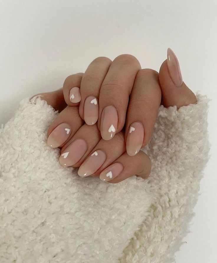 Charming Heart Accents on Nude Nails for a Romantic and Trendy Look