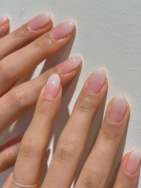 Sophisticated Ombre Nail Design with Sheer Pink Gradient and Ethereal Shimmer.