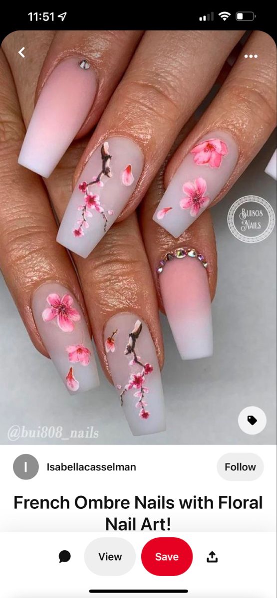 Elegant Ombre French Nails with Floral Designs and Subtle Gem Accents.