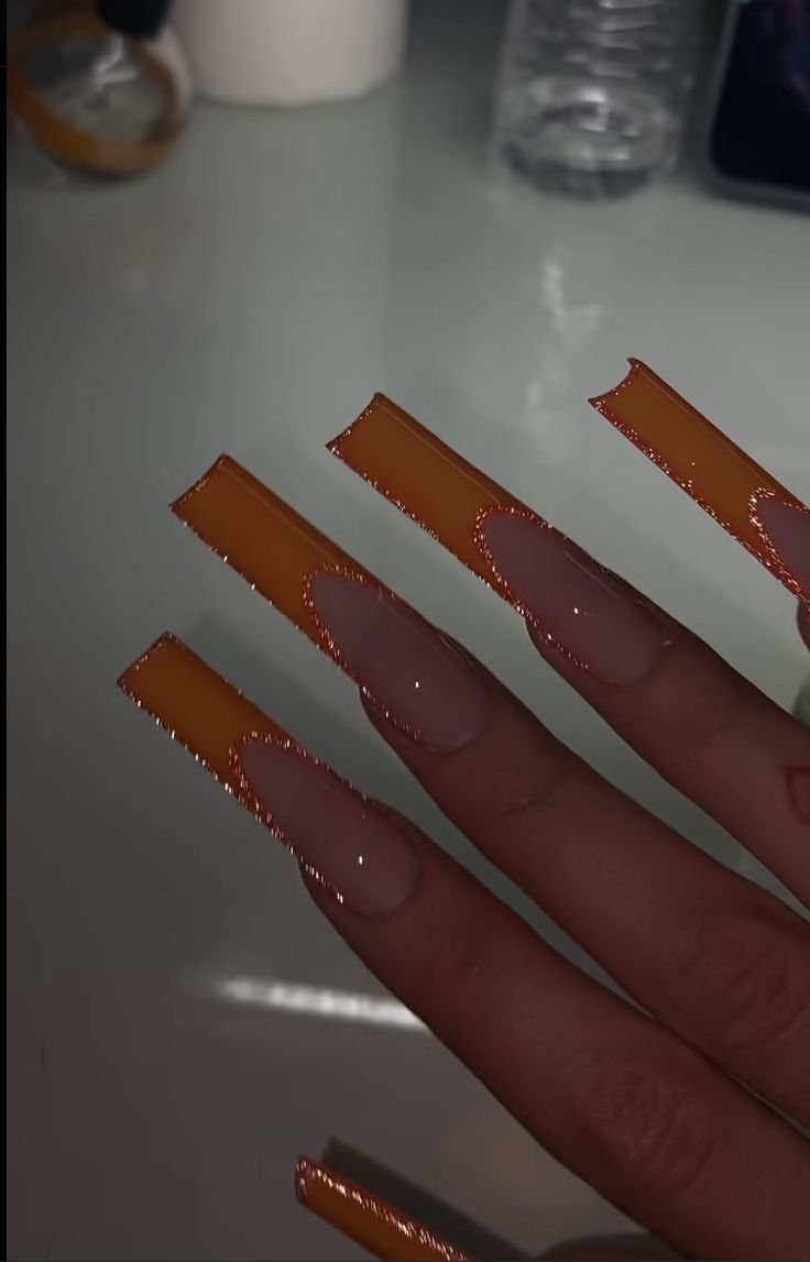 Bold Vibrant Nail Design with Long Square Tips in Clear and Bright Orange Color Blocking.