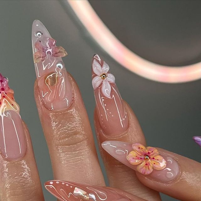 Elegant Floral Nail Design with Glossy Tips and Pastel Colors.