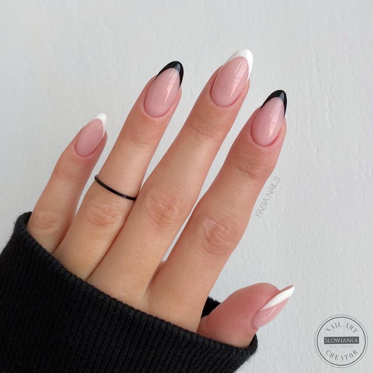 Chic Almond-Shaped Nails with Nude Base and Bold Black-and-White Tips for Modern Elegance.