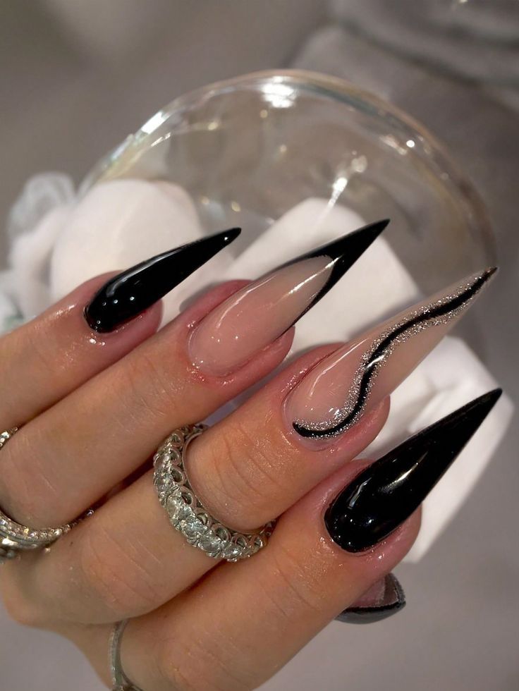 Chic Black and Nude Stiletto Nails with Shimmering Accent.