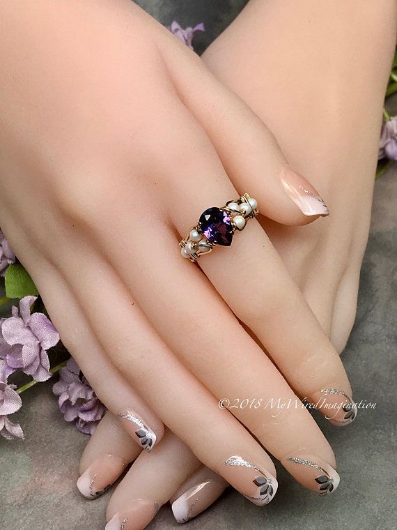 Elegant Nude Nail Design with Silver Tips and Floral Accents