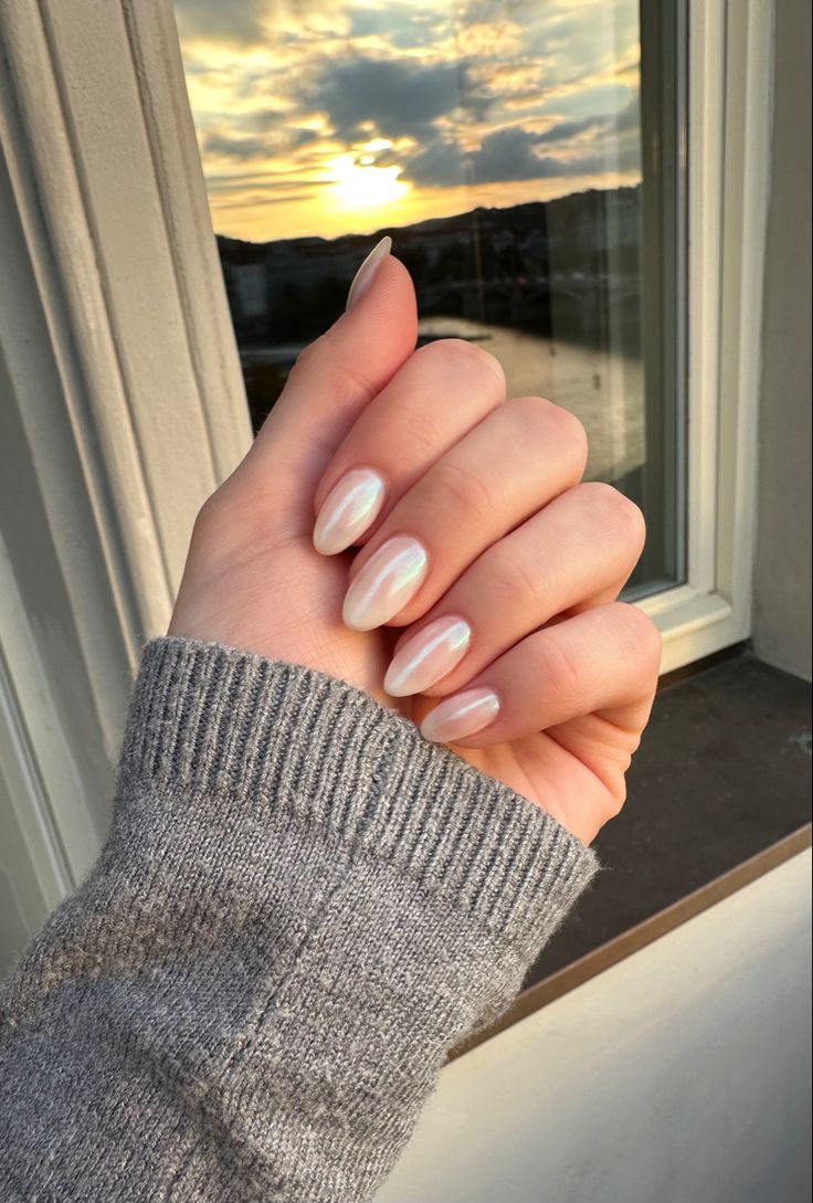 Elegant Almond-Shaped Nails with Pearlescent Finish: A Stylish and Cozy Ensemble.