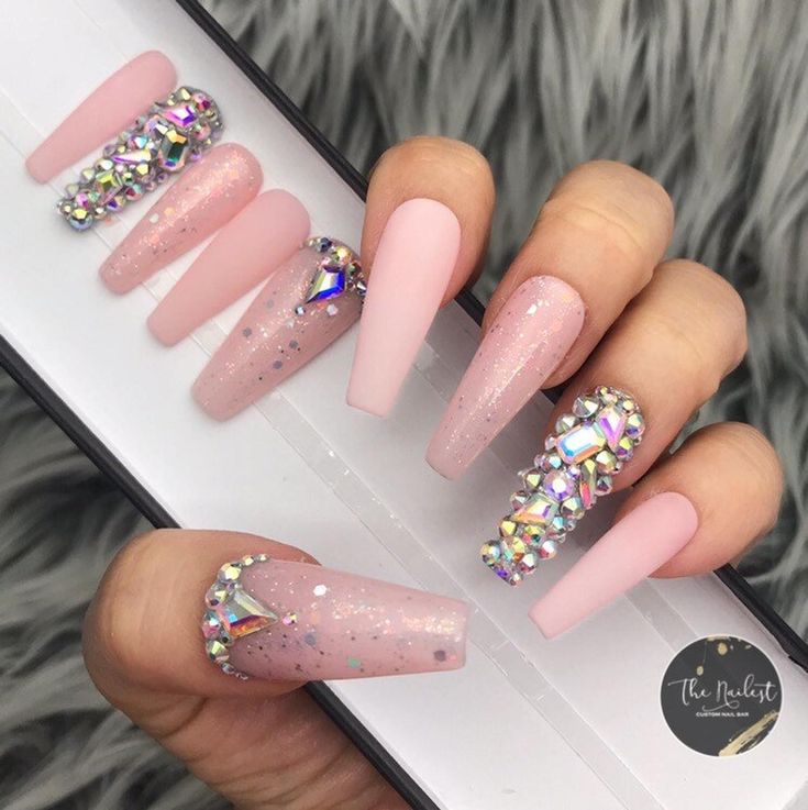 Sophisticated Soft Pink Nail Design with Glossy and Matte Finishes, Rhinestones, and Glitter Accents.