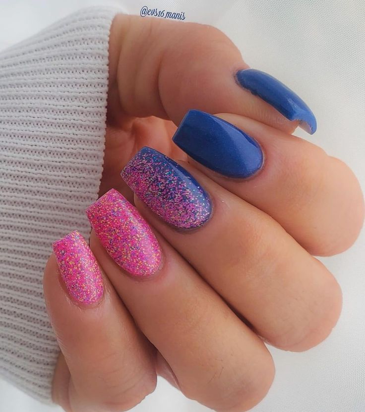 Vibrant Manicure: Playful Textures with Shimmering Pink and Purple Glitter Against Bold Blue Polish.