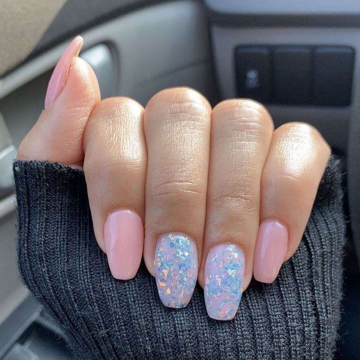 Chic Pastel Pink Nail Design with Iridescent Glitter Accent.