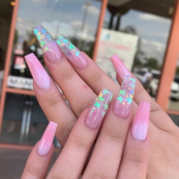 Whimsical Elongated Nail Design with Gradient Effect and Butterfly Glitter Accents