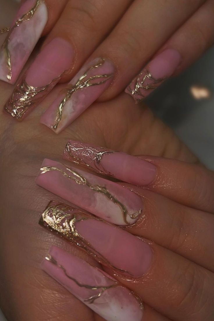 Sophisticated Almond-Shaped Nails: Elegant Pink Marble Design with Gold Accents for Glamorous Occasions.