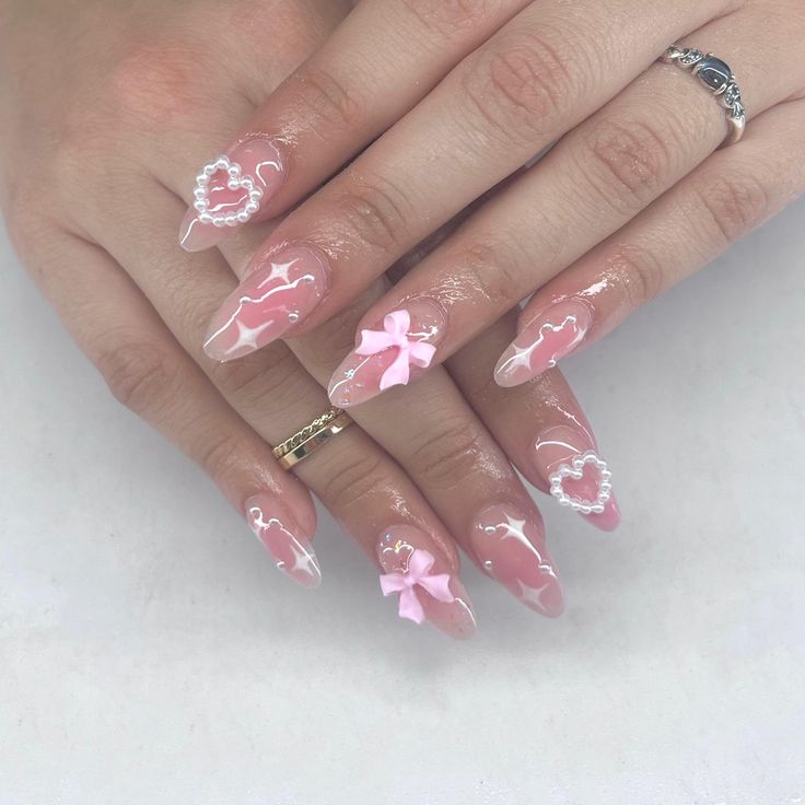 Whimsical Pink and White Nail Design with Bows and Pearls