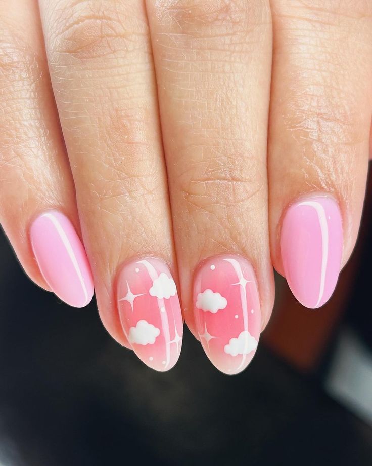 Dreamy Whimsical Nail Design with Soft Pink Base and Playful Cloud Patterns