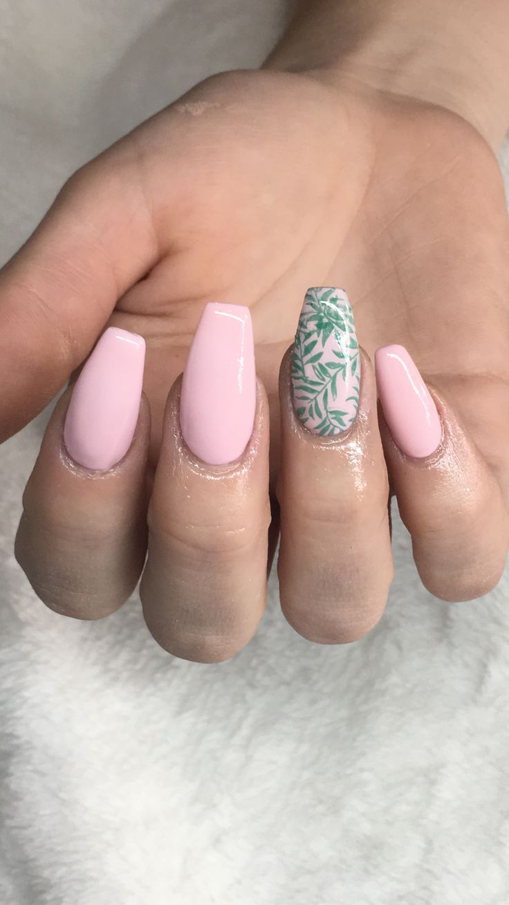 Chic Nail Design: Soft Pink Base with Vibrant Green Leaf Accent for a Stylish Look.