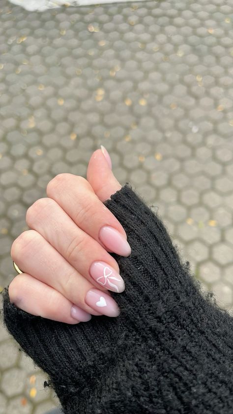 Charming Almond-Shaped Nail Design with Neutral Base and Delicate White Accents