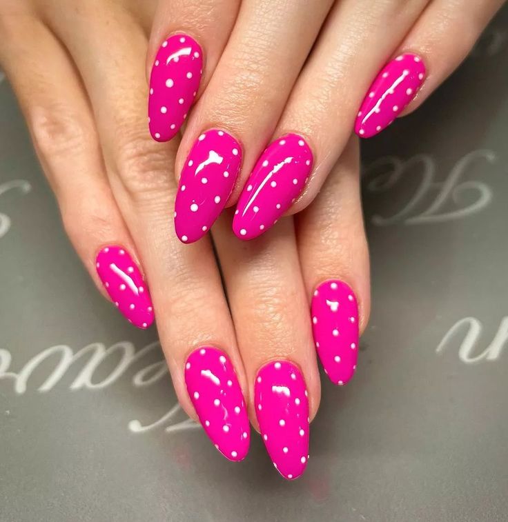 Cheerful Pink and White Polka Dot Oval Nails for a Playful Manicure.