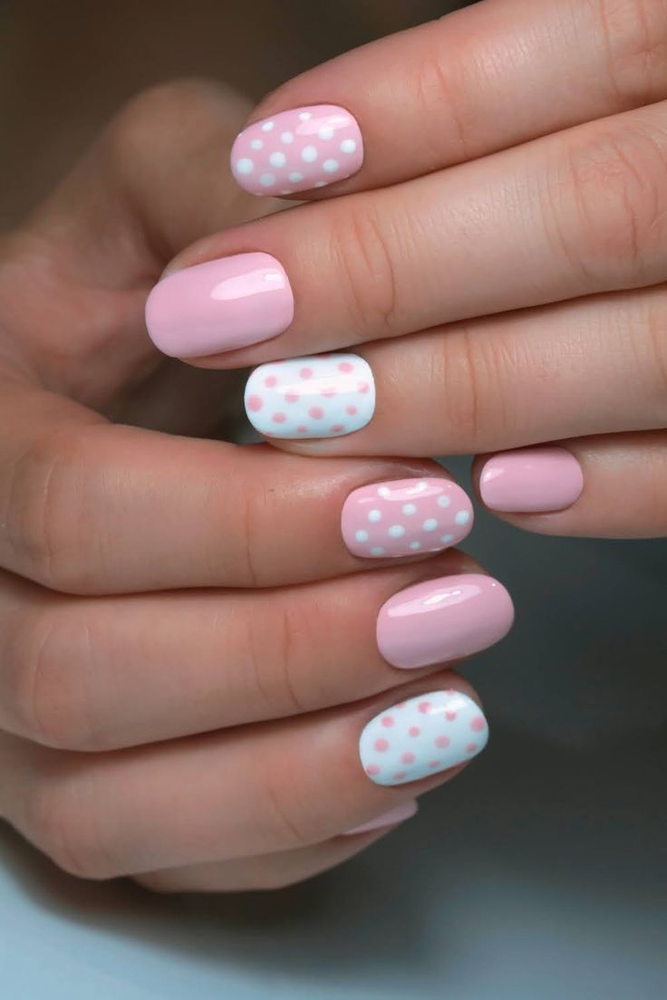 Charming Pastel Pink Nail Design with Solid and Dotted Patterns.