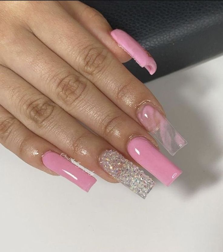 Chic Pastel Pink Coffin Nails with Glitter Accents and Artistic Swirl Design.