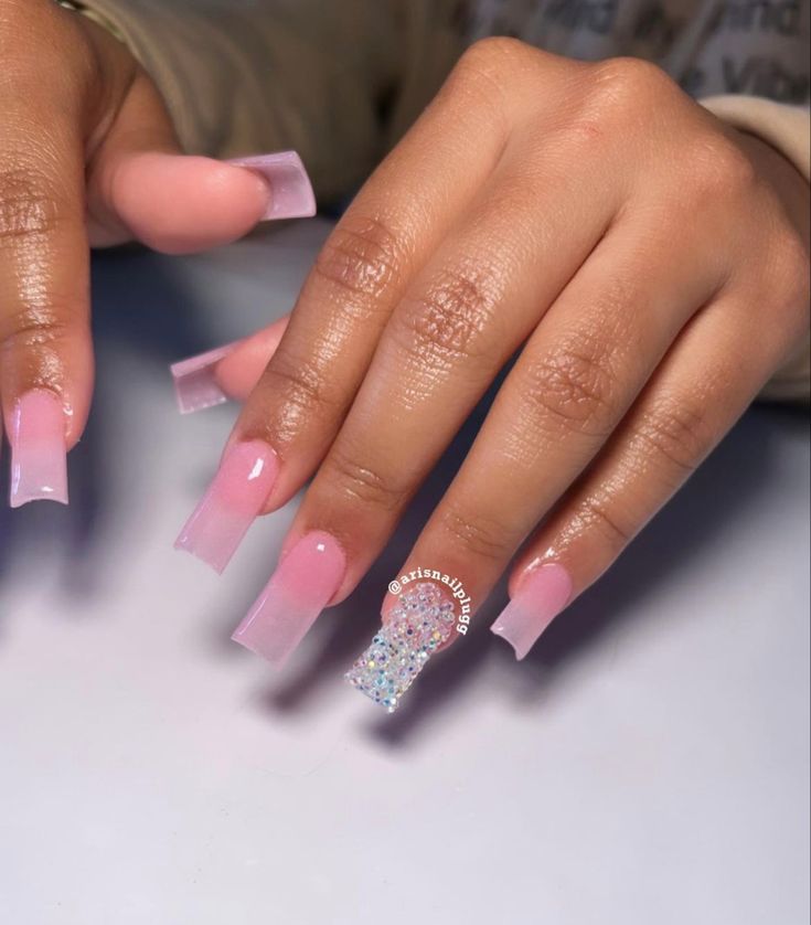 Elegant Translucent Pink Ombre Nail Design with Glamorous Gem Accents