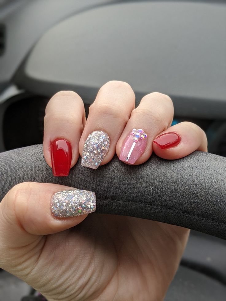 Chic and Eye-Catching Nail Design: Bold Red, Shimmering Silver, and Playful Pink Accents.