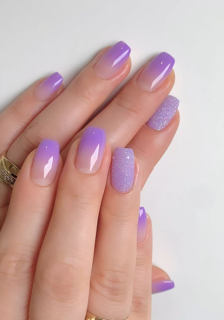 Elegant Gradient Purple Nail Design with Glossy Finishes and Sparkling Accents.