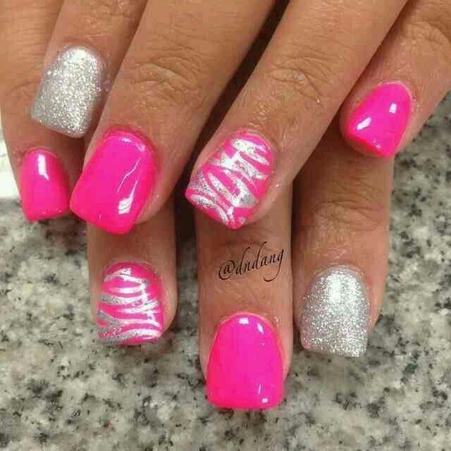 Playful Vibrant Pink and Silver Nail Design with Glitter and Zebra Stripes.