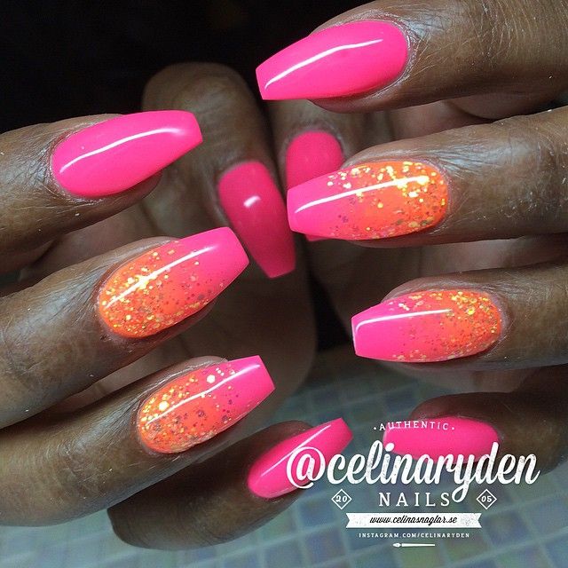 Bold Vibrant Pink Nails with Playful Orange Glitter Accents for a Fun Look.