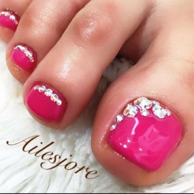 Chic Vibrant Pink Toenail Design with Sparkling Rhinestones for Bold Summer Style.