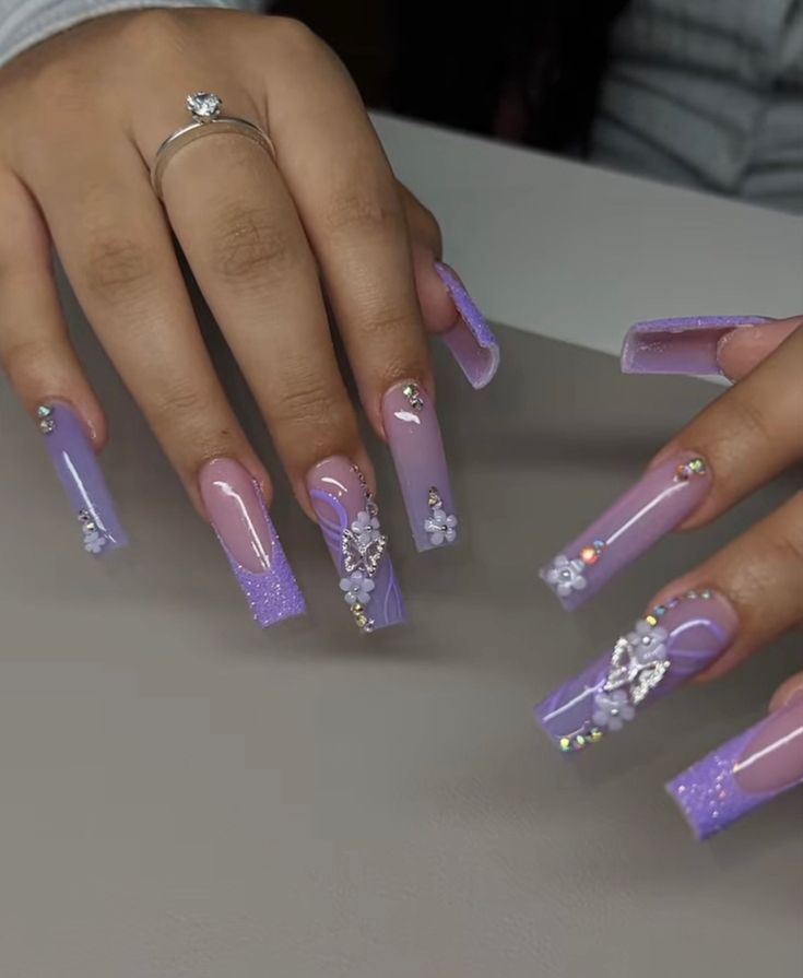 Glamorous Lavender-Inspired Acrylic Nail Design with Floral Embellishments and Rhinestones.