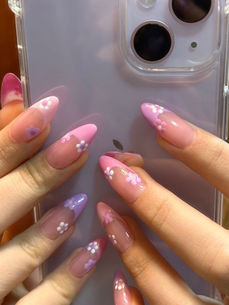 Vibrant Pink and Lavender Nail Designs with Delicate Floral Accents for Elegance and Playfulness.