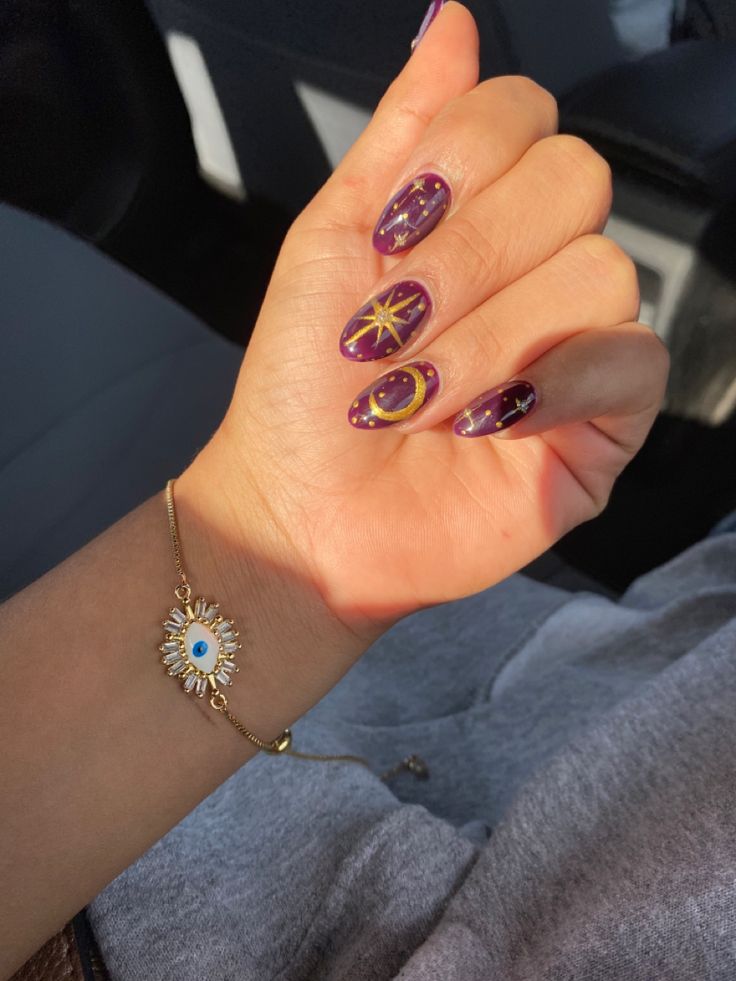 Celestial-Inspired Nail Design with Deep Purple Base and Gold Accents.