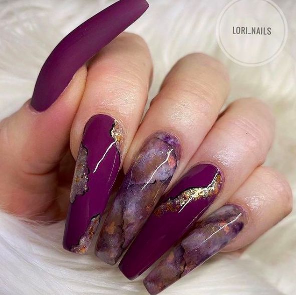 Luxurious Long Oval Nail Design in Plum and Purple with Gold Accents and Marbled Effect.