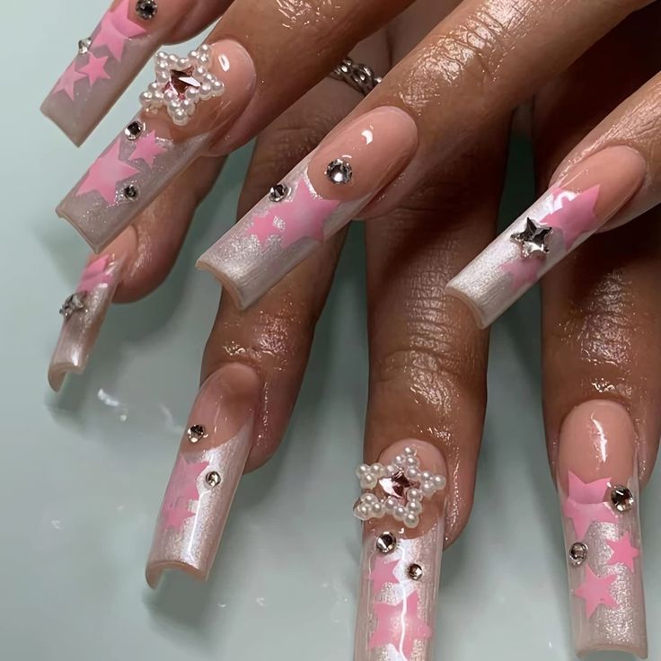 Elegant Long Square Nail Design with Soft Pink and White, Embossed Stars, Rhinestones, and Pearl Accents