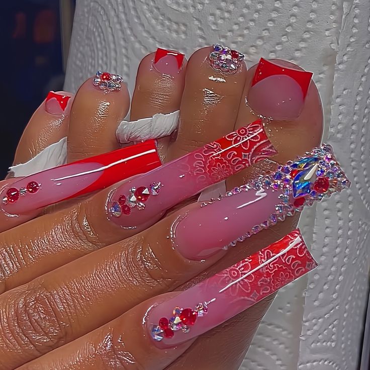 Glamorous Red and Pink Nail Design with Sparkling Rhinestones and Intricate Patterns