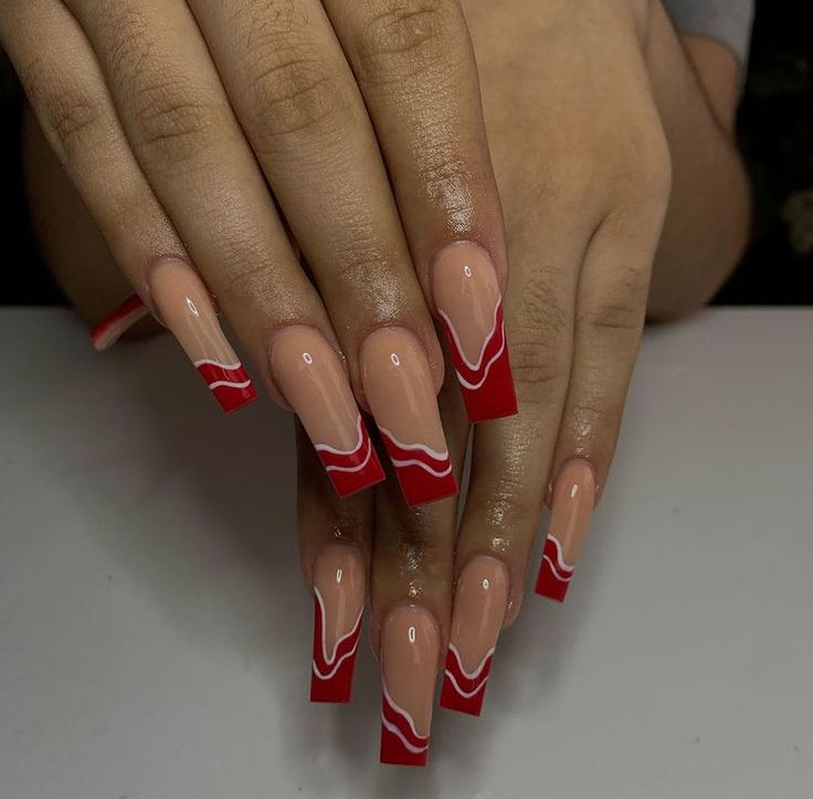 Elegant Bold Red and Nude Nail Design with Fluid White Accents.